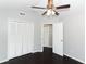 Bedroom with dark hardwood floors and double doors to closet at 3473 Hillmont Cir, Orlando, FL 32817