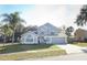 Two-story house with gray siding, arched windows, and a two-car garage at 3473 Hillmont Cir, Orlando, FL 32817