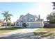 Two-story house with gray siding, landscaped lawn, and a two-car garage at 3473 Hillmont Cir, Orlando, FL 32817