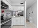 Modern white kitchen with granite countertops and stainless steel appliances at 425 Wymore Rd # 203, Altamonte Springs, FL 32714