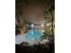 Community pool at night with surrounding landscape lighting at 425 Wymore Rd # 203, Altamonte Springs, FL 32714