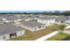 Aerial view of a new home community with houses featuring solar panels at 429 Tisone Ln, Davenport, FL 33837