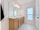 Bathroom with double sinks and light wood cabinets at 429 Tisone Ln, Davenport, FL 33837