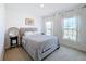 Well-lit bedroom with gray bedding and large windows at 429 Tisone Ln, Davenport, FL 33837