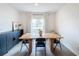 Bright dining room features a wood table with four chairs and a built-in cabinet at 429 Tisone Ln, Davenport, FL 33837