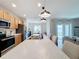 Modern kitchen with an island, stainless steel appliances, and light wood cabinets at 429 Tisone Ln, Davenport, FL 33837