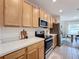 Modern kitchen with stainless steel appliances and light wood cabinets at 429 Tisone Ln, Davenport, FL 33837