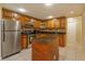 Kitchen with wood cabinets, granite island, and stainless steel appliances at 4355 E Michigan St # 4355, Orlando, FL 32812