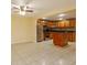 Kitchen with wood cabinets, island, and stainless steel appliances at 4355 E Michigan St # 4355, Orlando, FL 32812