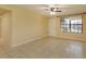 Living room with tile floors, window, and ceiling fan at 4355 E Michigan St # 4355, Orlando, FL 32812