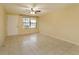 Living room with tile floors, window, and ceiling fan at 4355 E Michigan St # 4355, Orlando, FL 32812