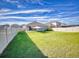 Spacious backyard with shade sail and fence at 4462 Lions Gate Ave, Clermont, FL 34711