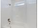 White tiled bathroom with a bathtub and shower at 4462 Lions Gate Ave, Clermont, FL 34711