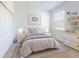 Bedroom with gray bedding, white dresser, and shelving at 4462 Lions Gate Ave, Clermont, FL 34711