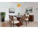 Modern dining room with wood table, art, and stylish light fixture at 4462 Lions Gate Ave, Clermont, FL 34711