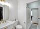 Modern bathroom with white vanity, gold accents, and shower at 4833 Cypress Woods Dr # 4101, Orlando, FL 32811