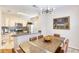 Dining area with wood table and leather chairs next to kitchen at 4833 Cypress Woods Dr # 4101, Orlando, FL 32811