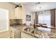 Kitchen with granite countertops, stainless steel appliances, and breakfast bar at 4833 Cypress Woods Dr # 4101, Orlando, FL 32811