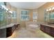 Elegant bathroom featuring a large soaking tub and double vanities at 4847 Shoreline Cir, Sanford, FL 32771