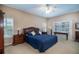 Main bedroom with a king-size bed, window seating, and ample natural light at 4847 Shoreline Cir, Sanford, FL 32771