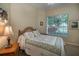 Cozy guest bedroom with a queen-size bed and a peaceful view at 4847 Shoreline Cir, Sanford, FL 32771