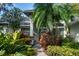 Inviting front entrance with a walkway and tropical plants at 4847 Shoreline Cir, Sanford, FL 32771