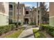 Exterior view of condo building with walkway and landscaping at 4897 Cypress Woods Dr # 6303, Orlando, FL 32811