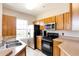 Modern kitchen featuring stainless steel appliances and wood cabinets at 4897 Cypress Woods Dr # 6303, Orlando, FL 32811