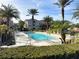 Resort-style pool with lounge chairs and palm trees at 4897 Cypress Woods Dr # 6303, Orlando, FL 32811