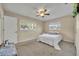 Spacious bedroom with a queen-size bed and ceiling fan at 720 E Iris Dr, Orange City, FL 32763