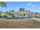 Cute yellow house with white trim and landscaped lawn at 720 E Iris Dr, Orange City, FL 32763