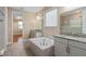 Spacious bathroom with double vanity and a large soaking tub at 8324 Vivaro Isle Way, Windermere, FL 34786