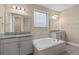 Bathroom boasts double sinks, granite counters, and a relaxing soaking tub at 8324 Vivaro Isle Way, Windermere, FL 34786