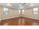 Spacious bedroom with hardwood floors, high ceilings and multiple windows at 8324 Vivaro Isle Way, Windermere, FL 34786