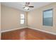 Well-lit bedroom with hardwood floors and two windows at 8324 Vivaro Isle Way, Windermere, FL 34786