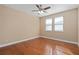 Well-lit bedroom with hardwood floors and two windows at 8324 Vivaro Isle Way, Windermere, FL 34786