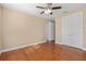 Bedroom with hardwood floors, ceiling fan, and double doors at 8324 Vivaro Isle Way, Windermere, FL 34786