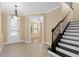 Bright entryway with tiled floors, a view into the living area, and a grand staircase at 8324 Vivaro Isle Way, Windermere, FL 34786