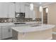 Kitchen island with sink, granite countertop, and modern pendant lighting at 8324 Vivaro Isle Way, Windermere, FL 34786