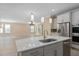 Modern kitchen island with sink and breakfast bar, open to living room at 8324 Vivaro Isle Way, Windermere, FL 34786