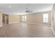 Spacious living room featuring hardwood floors, neutral walls, and a ceiling fan at 8324 Vivaro Isle Way, Windermere, FL 34786