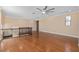 Large loft with hardwood floors, multiple windows, and ceiling fan at 8324 Vivaro Isle Way, Windermere, FL 34786