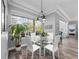 Bright dining area with glass table and four white chairs at 837 Ashbrooke Ct, Lake Mary, FL 32746