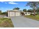 Newly renovated home showcasing a two-car garage and large driveway at 105 Clyde Ave, Longwood, FL 32750