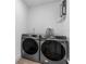 Bright laundry room with side-by-side Samsung washer and dryer at 105 Clyde Ave, Longwood, FL 32750