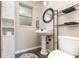 Clean bathroom with pedestal sink, toilet and linen shelving at 109 Wynot Way, Deland, FL 32724