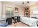 Bedroom with a single bed, built-in shelving and window at 109 Wynot Way, Deland, FL 32724