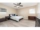 Bright bedroom with double bed, gray flooring, and ceiling fan at 109 Wynot Way, Deland, FL 32724