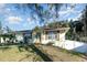 Light green house exterior, landscaped yard, and partial white fence at 109 Wynot Way, Deland, FL 32724