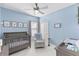 Charming Bedroom with gray crib and calming blue walls at 11560 Ashlin Park Blvd, Windermere, FL 34786